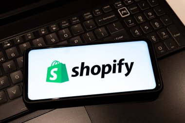 Shopify logo on smartphone screen  , background is a keyboard  , Sydney Australia July 30 2022