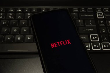 Netflix logo on mobile phone , background is a keyboard  , Sydney Australia July 30 2022