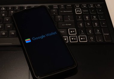 google wallet logo on mobile phone , background is a keyboard  , Sydney Australia July 30 2022