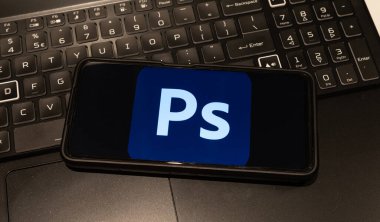 Photoshop logo on mobile phone  , background is a keyboard  , Sydney Australia July 30 2022