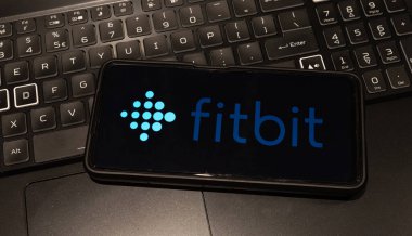 fitbit logo on mobile phone  , background is a keyboard  , Sydney Australia July 30 2022