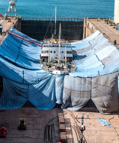 boat undergoing repairs in dry dock at falmouth, cornwall