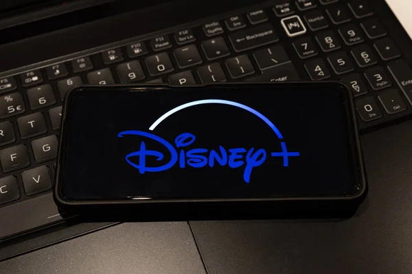 disney logo on mobile phone  , background is a keyboard  , Sydney Australia July 30 2022