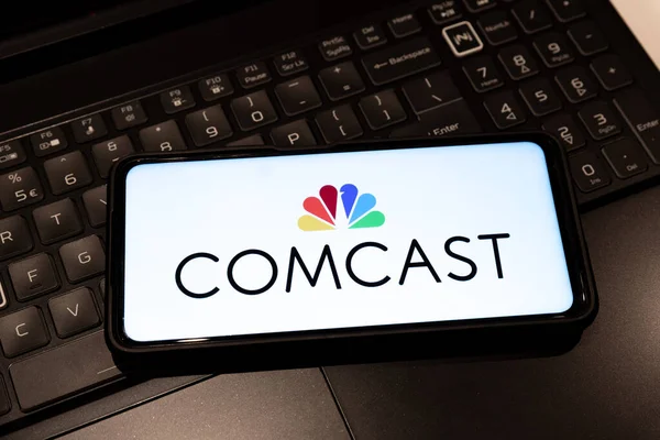 Comcast logo on mobile phone , background is a keyboard  , Sydney Australia July 30 2022