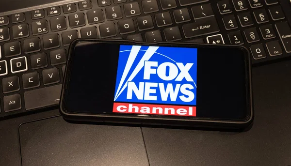 fox news channel logo on mobile phone , background is a keyboard  , Sydney Australia July 30 2022