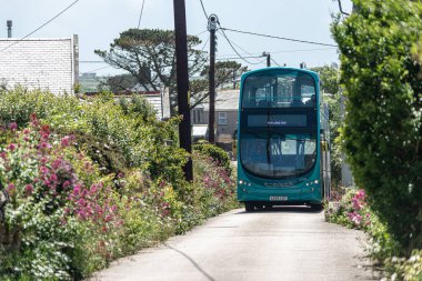 double decker bus driving the narrow lanes in cornwall , uk , June 10 - 2022