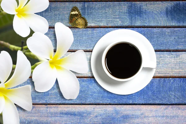 Fleur et tasse de café fond en bois — Photo