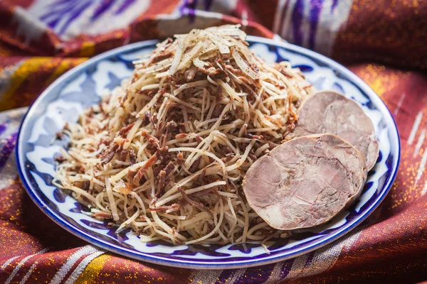 Uzbek national food on traditional fabric