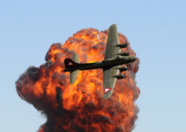 Old bomber against fireball clipart