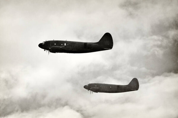 WW2 era transport airplanes carrying paratroopers on a mission black and white