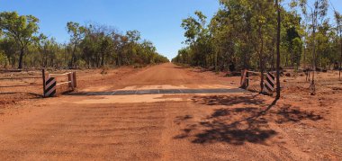 traveling on a dirt road crossing a cattle grid in Northern Territory border