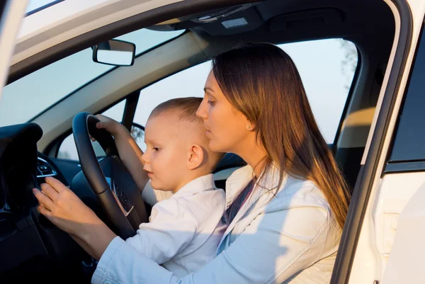 Mãe ensinando pequeno filho a dirigir — Fotografia de Stock