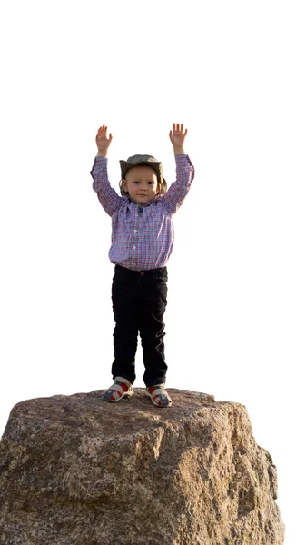 O menino triunfante na rocha rodeado de um fundo branco — Fotografia de Stock
