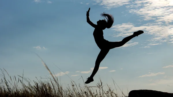 Silhouette of a graceful gymnast — Stock Photo, Image