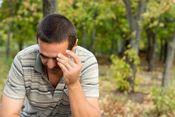 Worried man with hand to forehead — Stock Photo, Image