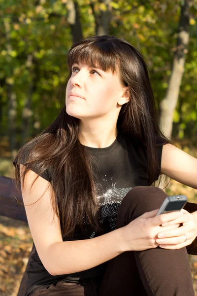 Woman daydreaming while waiting for a call — Stock Photo, Image