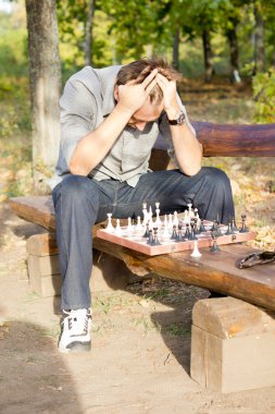 Chess player in despair clipart