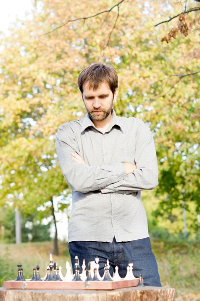 Man contemplating his next chess move — Stock Photo, Image