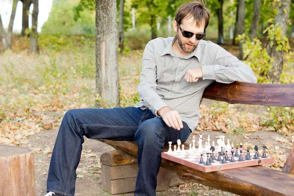 Man planning his next chess move — Stock Photo, Image