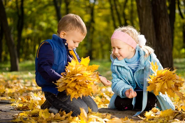 Brother and sister in autumn woodland — Stock Photo, Image