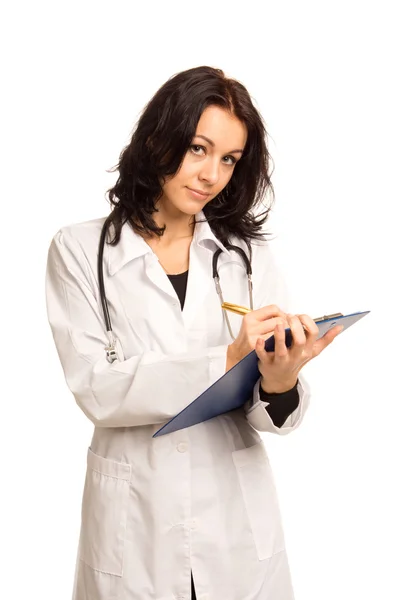 Young nurse writing up patient records — Stock Photo, Image