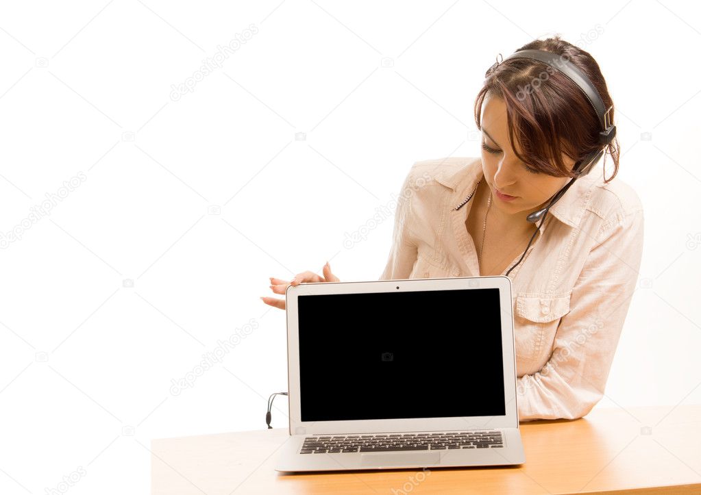Woman wearing a headset looking at her laptop