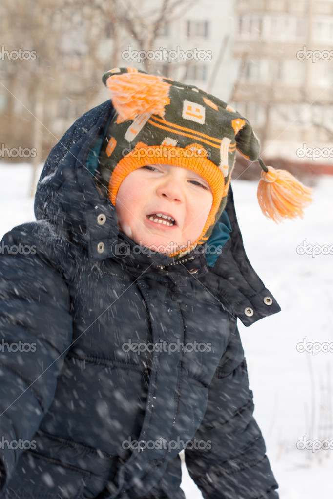 Cute little boy in a flurry of snow