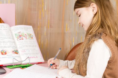 Little girl doing her homework clipart