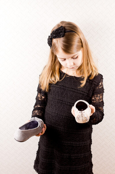 Little girl making a choice of shoes