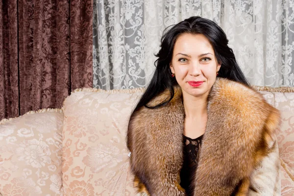 Happy woman in a luxurious fur coat — Stock Photo, Image