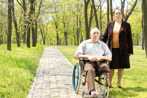 Handicapped elderly man with his wife — Stock Photo, Image