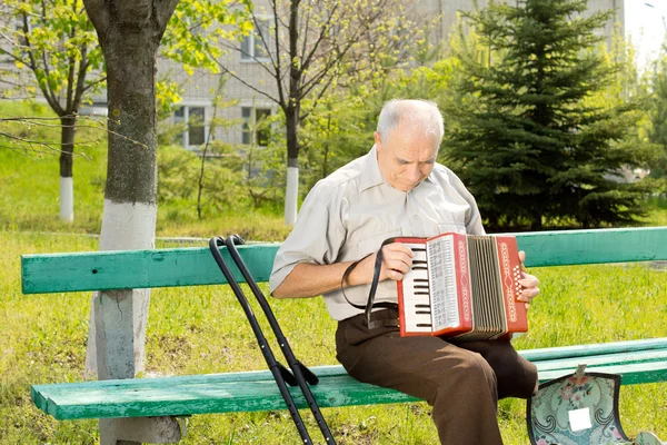 Handicapped man playing the accordion — Stock Photo, Image
