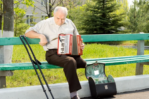 Handicapped senior man with an accordion — Stock Photo, Image