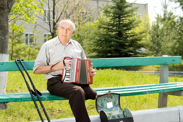 Disabled man playing the accordion — Stock Photo, Image