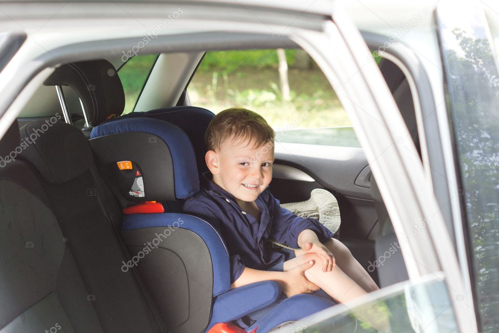 Happy little boy in a child seat