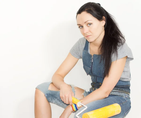 Serious woman with a paint roller — Stock Photo, Image