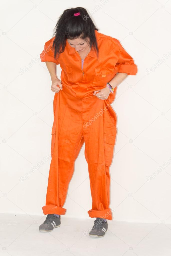 Woman in outsized orange overalls
