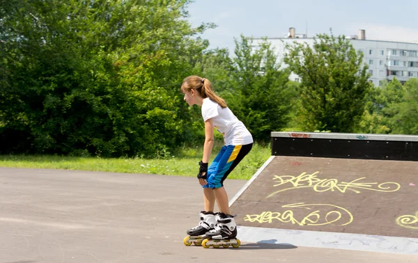 Active young girl roller skating — Stock Photo, Image