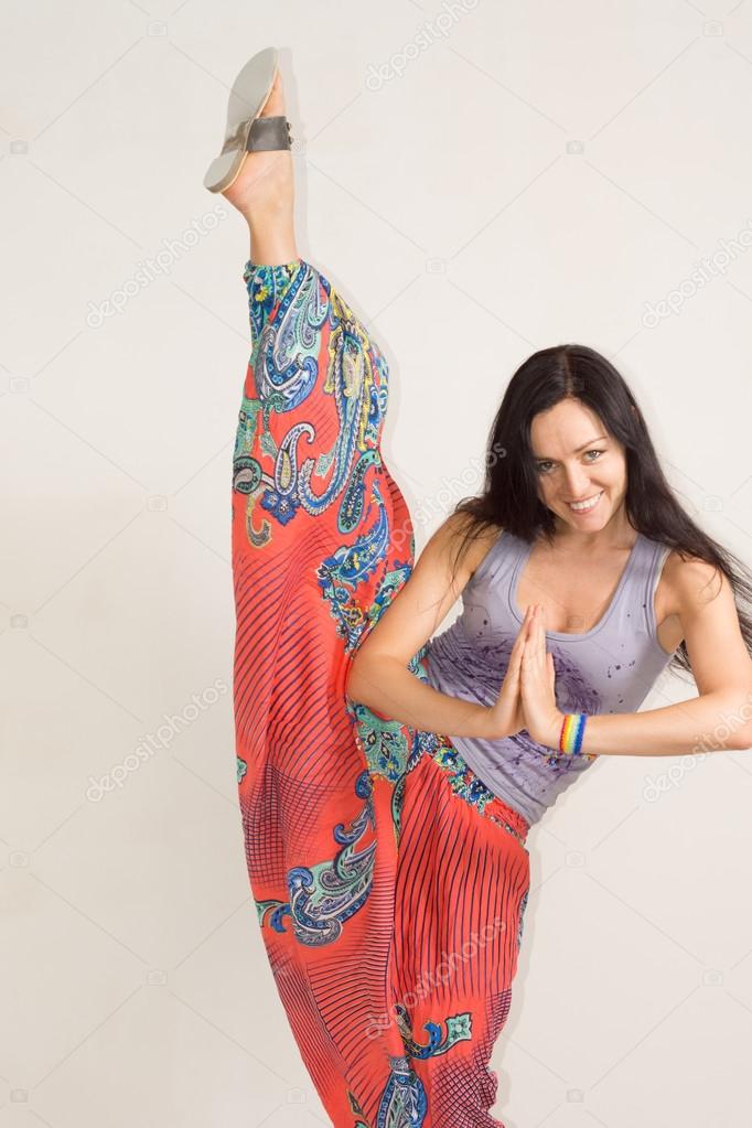 Supple young woman practising yoga