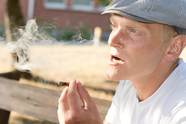 Pensive Caucasian middle-aged man smoking outdoors — Stock Photo, Image