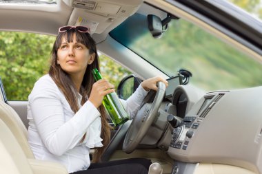 Woman drinking behind the wheel of her car clipart