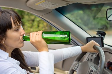 Drunk female driver in her car clipart
