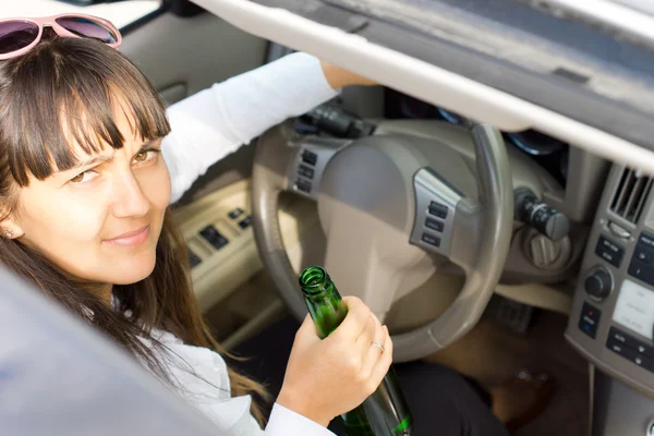 Drunk female driver sitting behind the wheel — Stock Photo, Image