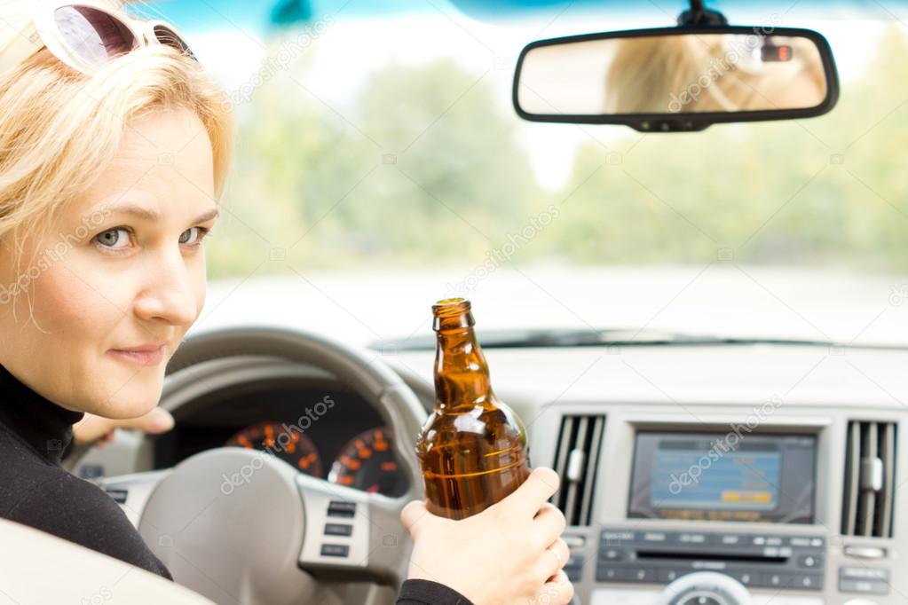 Smiling female driver drinking and talking