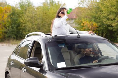 Two women drinking and driving clipart