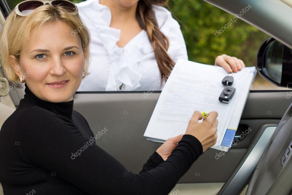 Woman purchasing a new car