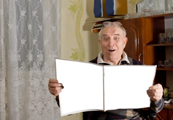 Elderly male pensioner reading a newspaper — Stock Photo, Image