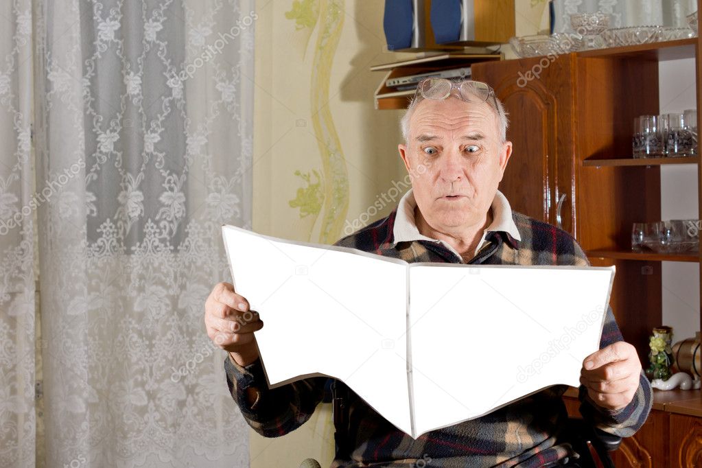 Elderly man ready a juicy bit of news in the paper