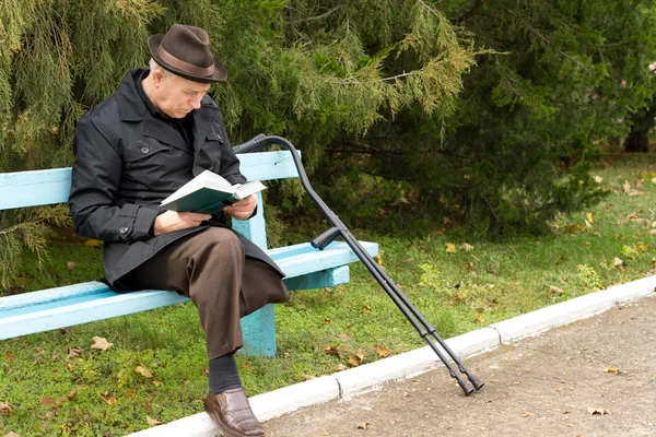 Senior amputee enjoying his book in the sunshine Stock Photo