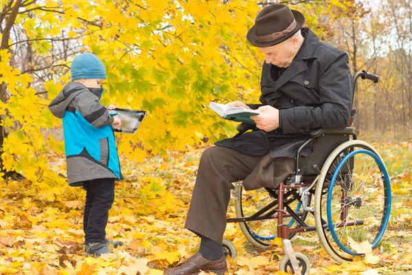 Small boy with his handicapped grandfather — Stock Photo, Image
